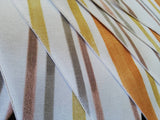 Stripy fabric bunting, mustard, yellow and shades of brown.