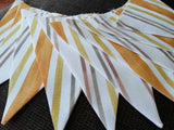 Stripy fabric bunting, mustard, yellow and shades of brown.