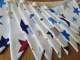 Colourful bunting with stars on cream cotton