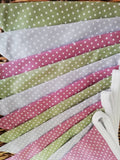Spotty bunting, dusky pink, sage green and dove grey.