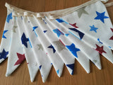 Colourful bunting with stars on cream cotton
