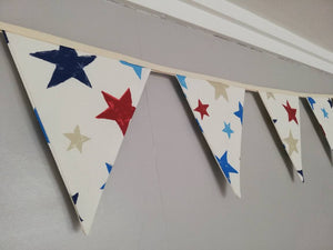 Colourful bunting with stars on cream cotton