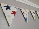 Colourful bunting with stars on cream cotton