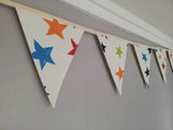 Colourful bunting with stars on cream cotton