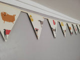 Stylistic dogs Fabric Bunting, on a cream background. 10 flags, approx 2.5 metres