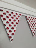 Ladybird fabric bunting, white background with red and black print, 10 flags, approx 2.5 metres