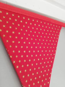 Gold star fabric bunting on red background, approx 2.5 metres